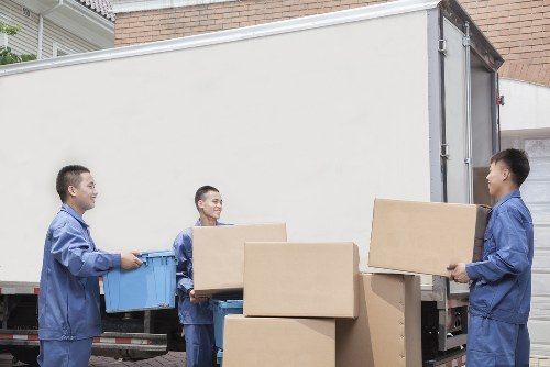 Removal team loading boxes and furniture for a London flat move