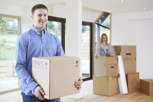 Professional movers packing office equipment for relocation