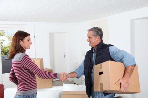 Removal crew handling furniture for a two-bedroom flat relocation